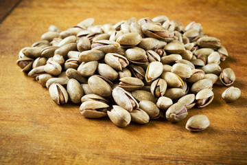 Pistachio nuts on wooden table