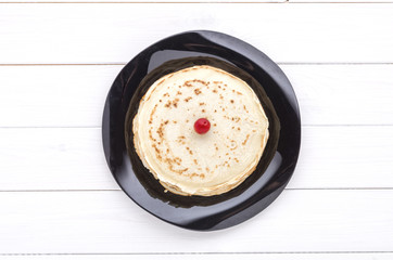 Pancakes with frozen cherry on white wooden background. Top view
