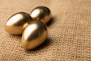 Beautiful festive golden quail eggs, easter background