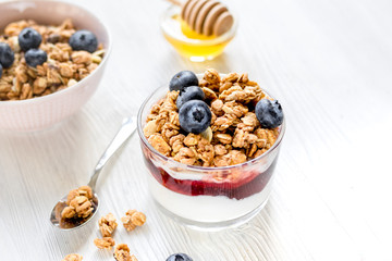 Healthy morning with granola breakfast on white kitchen table