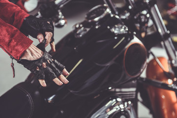 Fototapeta na wymiar Grandmother wearing accessory near motorcycle