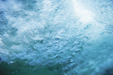 Fototapeta na wymiar Wave underwater. Blue wave and bubbles