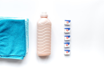 laundry set with towels and plastic bottels on white background top view