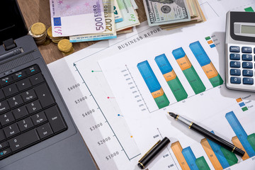 financial concept - business graph, euro, dollar and calculator on desk.