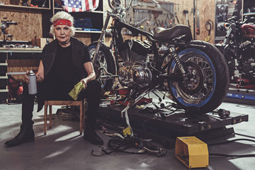 Serene female retire polishing motorcycle