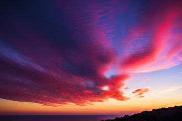 Fototapeta premium Beautiful sunset and clouds on sea. Sunset on ocean. Red and blue colors