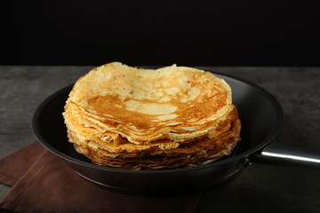 Pile of tasty pancakes in frying pan