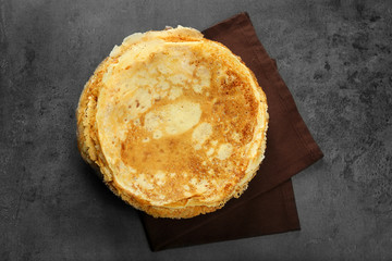 Stack of delicious pancakes on grey table
