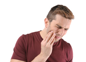 Young man suffering from toothache, closeup