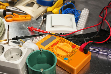 Electrician tools on metal background, closeup