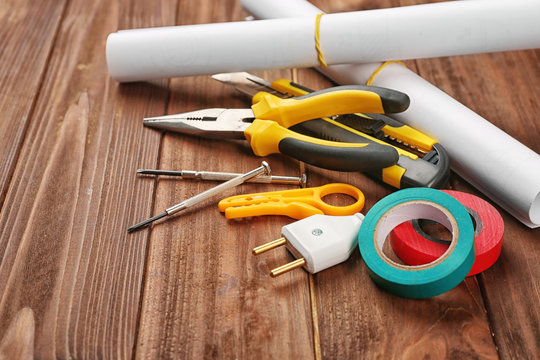 Electrician tools on wooden background