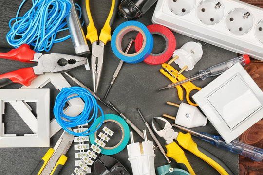 Different electrician tools on dark background
