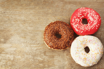 Glazed donuts on wooden background