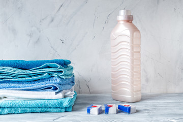 housekeeping set with towels and plastic bottles on laundry background mock-up