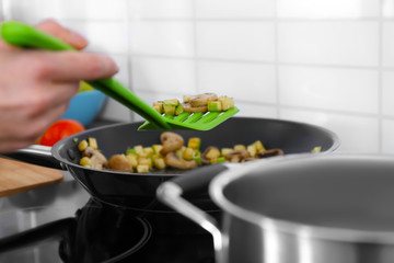Woman cooking delicious dinner at home