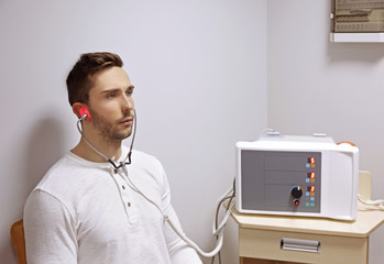 Young man undergoing light treatment in modern clinic