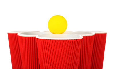 Plastic cups and tennis ball on white background. Beer pong concept