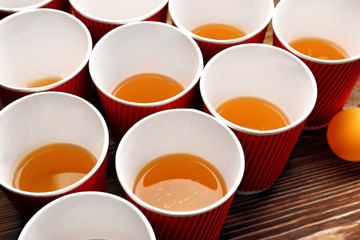 Plastic beer pong cups and ball on wooden table