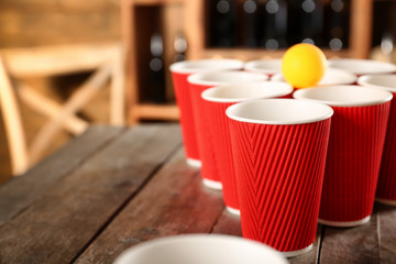 Plastic beer pong cups and ball, closeup
