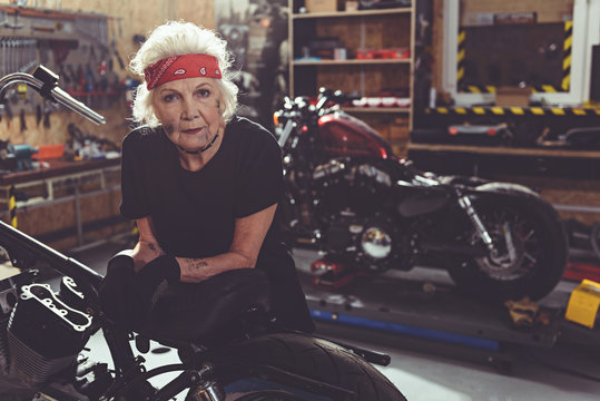 Cool Female Retiree Locating Next To Motorcycle