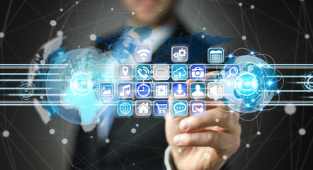 Businessman connecting worlds to icons and applications software 3D rendering