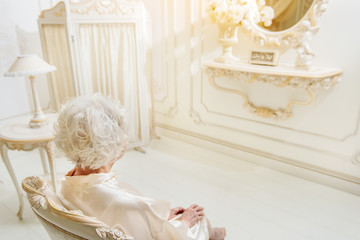 Senior lady relaxing on armchair
