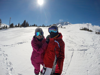 Fototapeta na wymiar Skiers couple on white skiing terrain