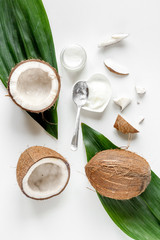 Fototapeta na wymiar organic cosmetics with coconut on white background top view