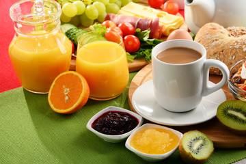 Breakfast served with coffee, orange juice, egg and fruits