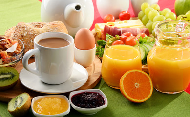 Breakfast served with coffee, orange juice, egg and fruits