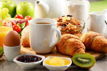 Breakfast served with coffee, orange juice, egg and fruits