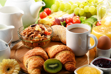 Breakfast served with coffee, orange juice, egg and fruits