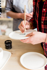 Fototapeta na wymiar workshop production of ceramic tableware product painting