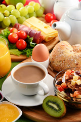 Breakfast served with coffee, orange juice, egg and fruits