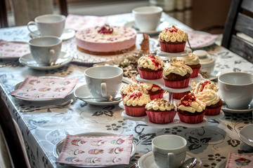 Cupcakes and cake on coffee table