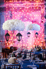 Wedding. Banquet. The chairs and round table for guests, served with cutlery and crockery and...