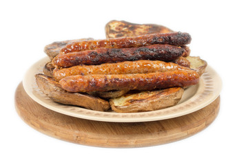 Baked potatoes with grilled bbq sausages on the plate