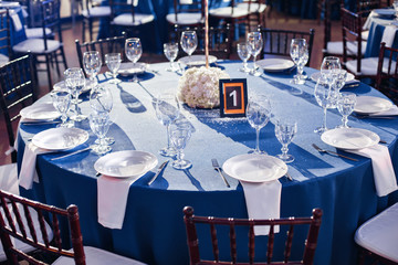 Wedding. Banquet. The chairs and round table for guests, served with cutlery and crockery and...
