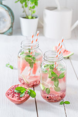 Sparkling water in jar with watermelon, pomegranate and mint leaves