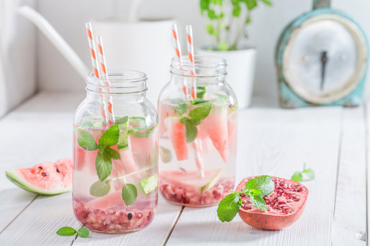 Healthy water in jar with pomegranate and watermelon