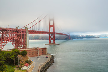 Aerial view of Golden Gate Bridge from Fort Point, south shore, symbol, icon and landmark of San Francisco, California, United States. Typical fog in summertime. Travel and holidays concept.
