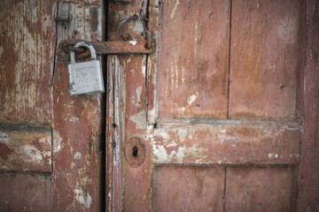 The old door locked with a padlock hanging brackets.