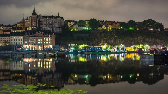 Time Lapse of Mariaberget Sodermalm in Stockholm city. Old buildings on hill, reflections in the water