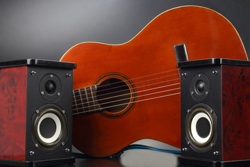 two stereo audio speakers and classical acoustic guitar