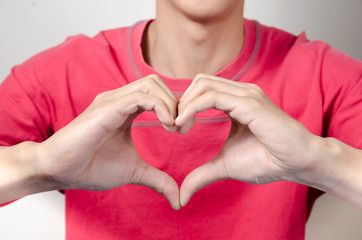 Asian young man make heart hand