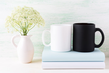 White and black mug mockup with books and white flowers