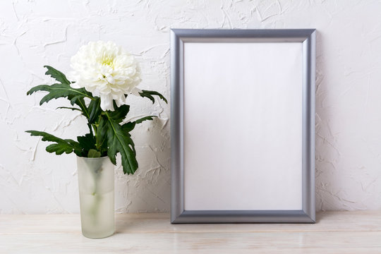 Silver frame mockup with white chrysanthemum in glass vase
