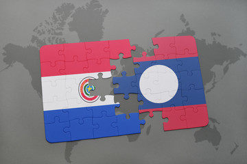 puzzle with the national flag of paraguay and laos on a world map