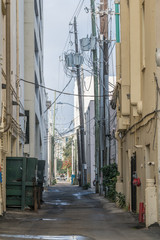 Fototapeta premium Alleyway cluttered with utilities