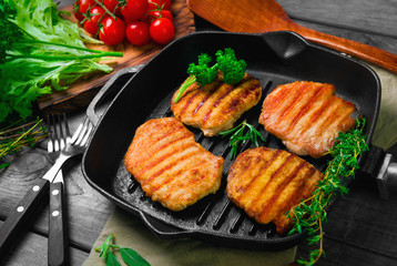 Four pieces of of grilled pork steaks